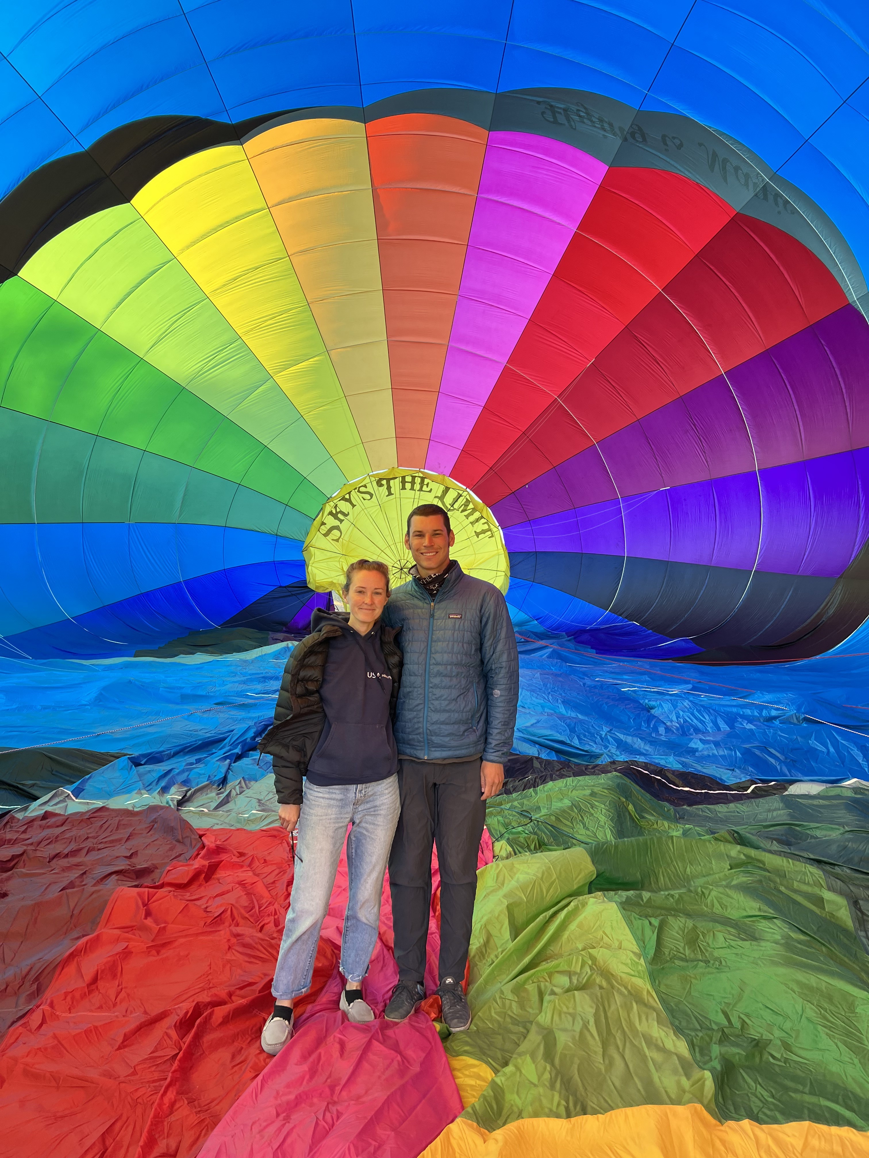 Guests inside a colorful Sky's The Limit Ballooning hot air balloon